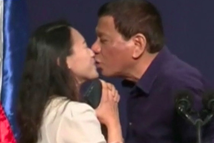 Philippine president criticised for kissing woman on stage
