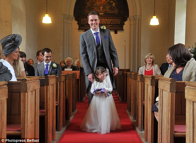 Flower girl takes her first steps thanks to dad