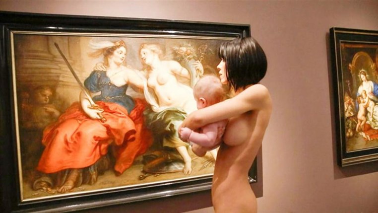  Woman walks around a German museum completely naked while holding a baby  