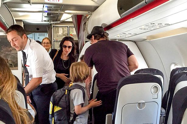 Angelina Jolie Brad Pitt and their six kids fly ECONOMY on a trip from Paris