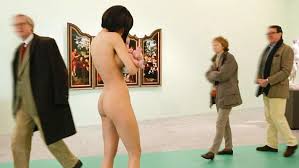  Woman walks around a German museum completely naked while holding a baby  