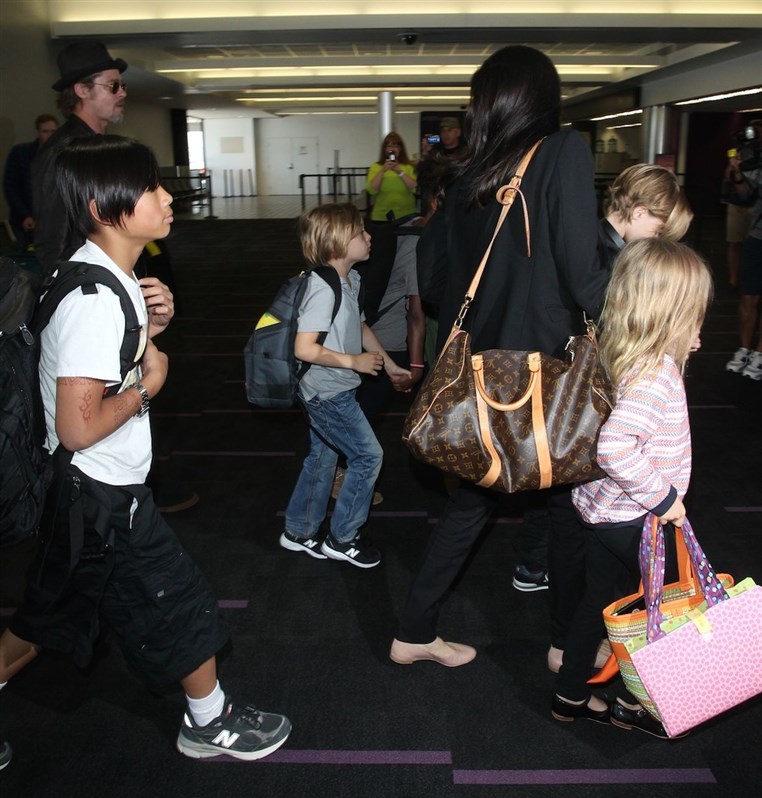 Angelina Jolie Brad Pitt and their six kids fly ECONOMY on a trip from Paris