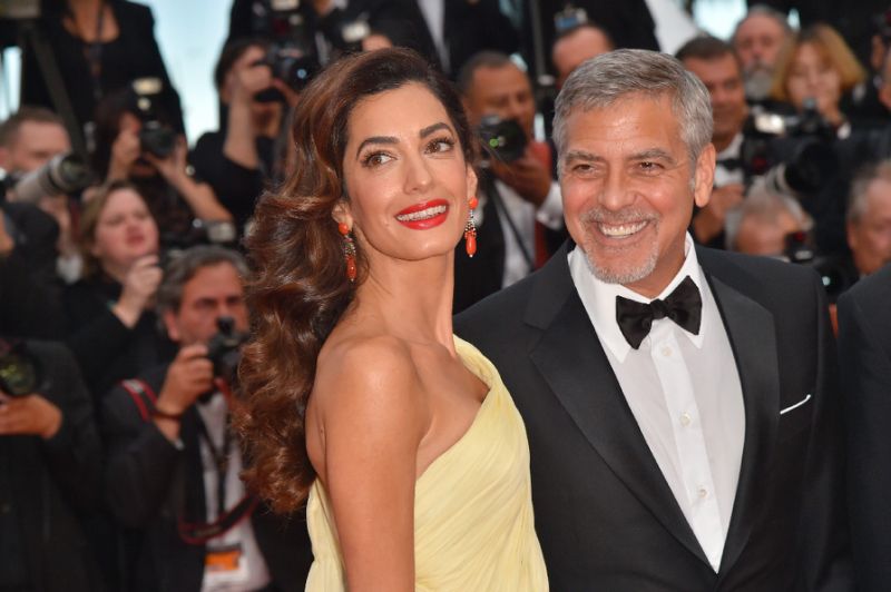 George and Amal Clooney are suing a magazine for publishing photos of their twins