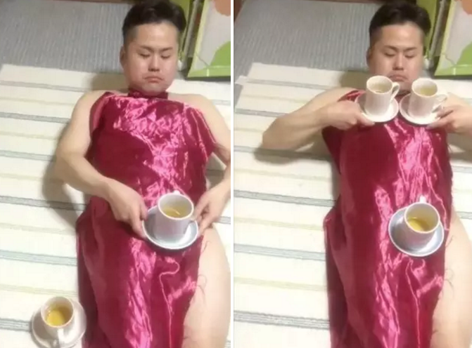 Naked man does a little trick with a cup and a tablecloth