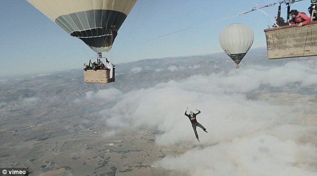 Daredevil tightrope walkers fall after attempting to tread between two hot air balloons 