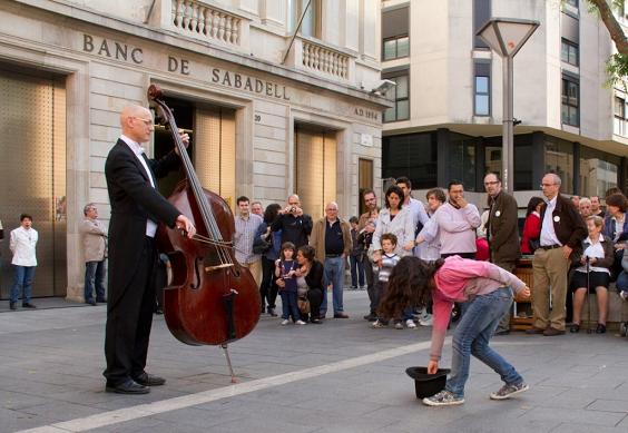 A little girl donates some coins to a street musician and gets the best surprise in return.