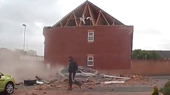 In Video: Man Casually Walks Past House As It Crashes Down To The Ground
