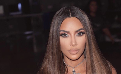 Kim Kardashian poses in a snakeskin-print bikini as she goes for a ‘night swim’